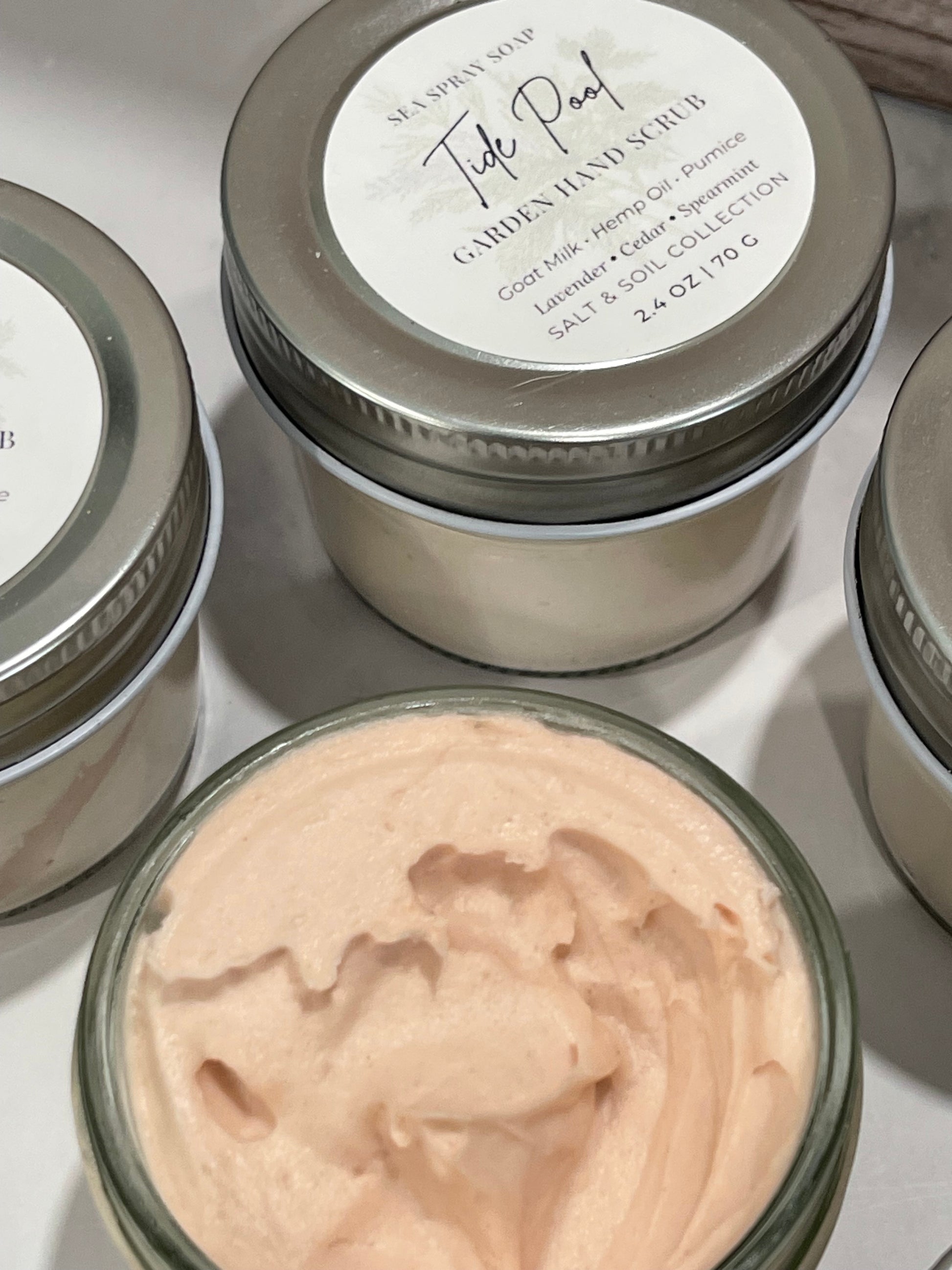 Jars of cream with visible brand name on a reflective surface