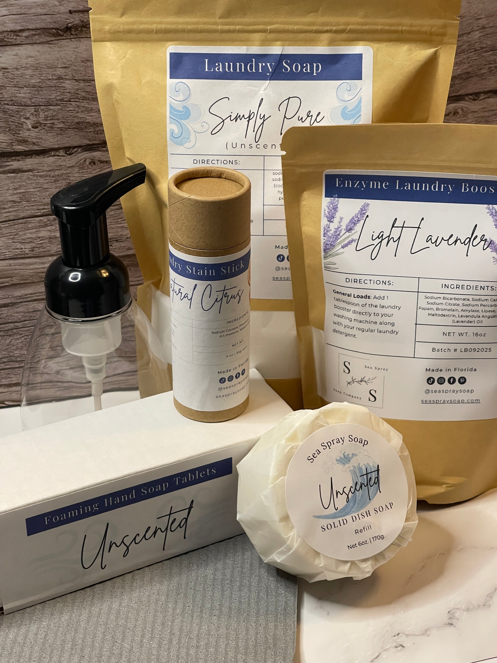 Collection of laundry and cleaning products including soap, detergent, and a bottle on a wooden surface.