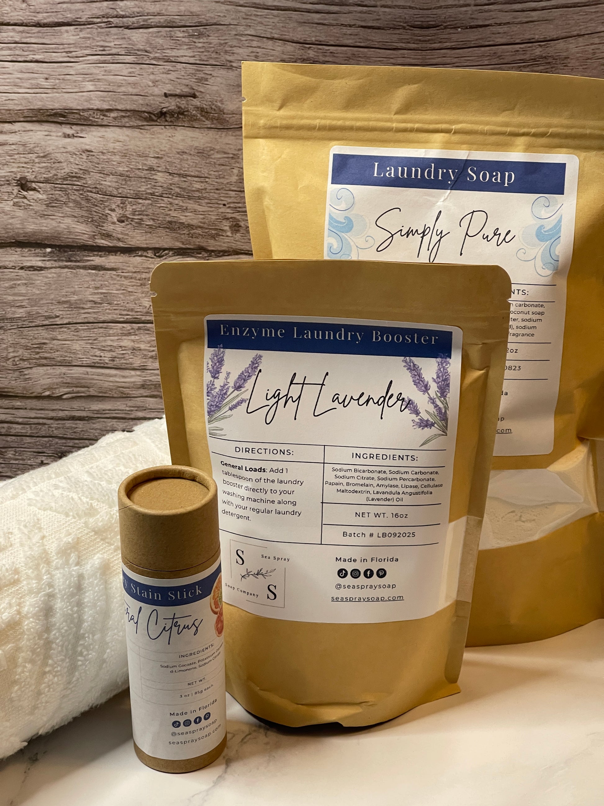 Three bags of Simply Pure laundry soap on a wooden surface