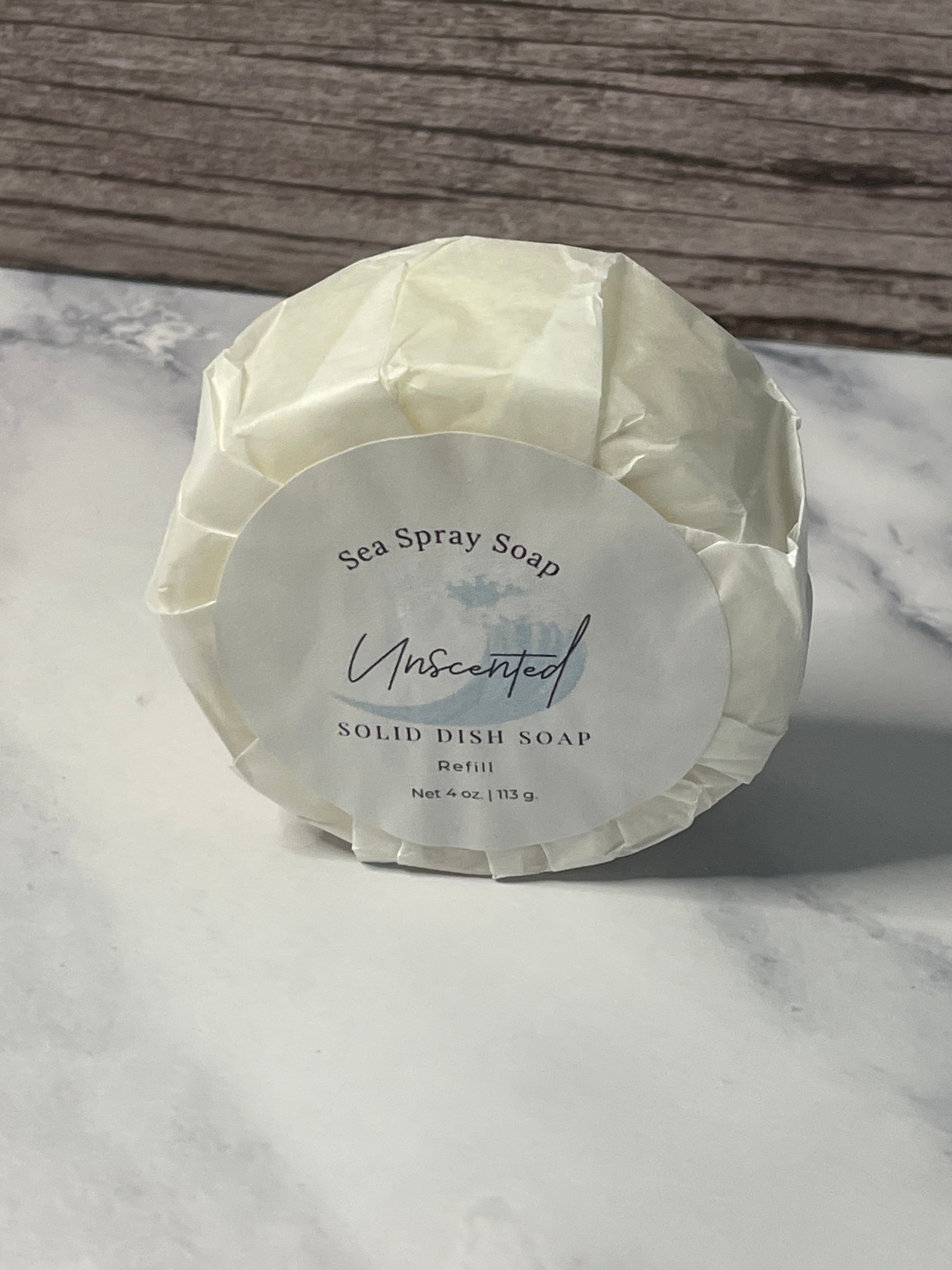 Solid dish soap bar with a label on a marble surface