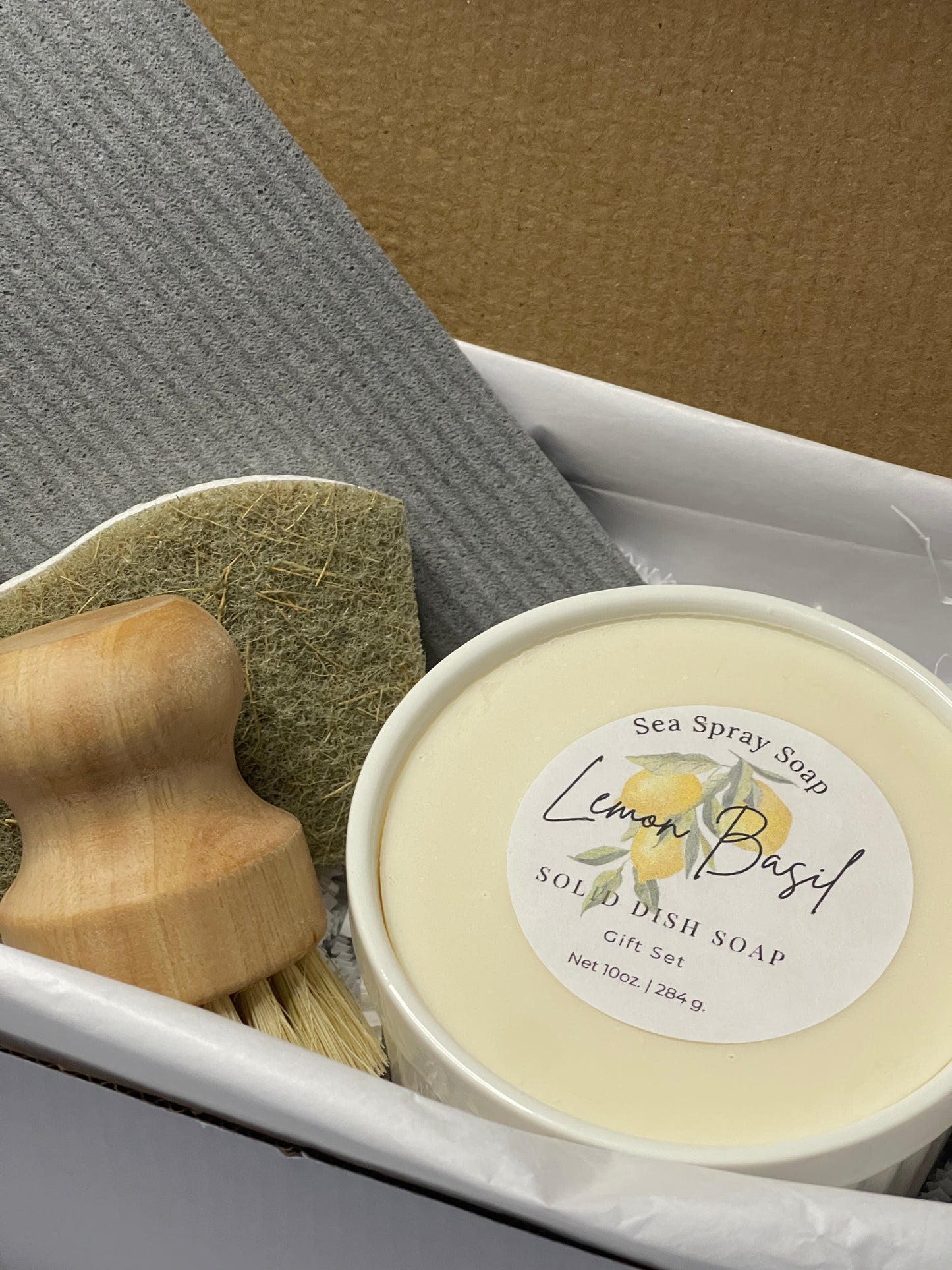 Bar of soap with a wooden spoon on a textured surface