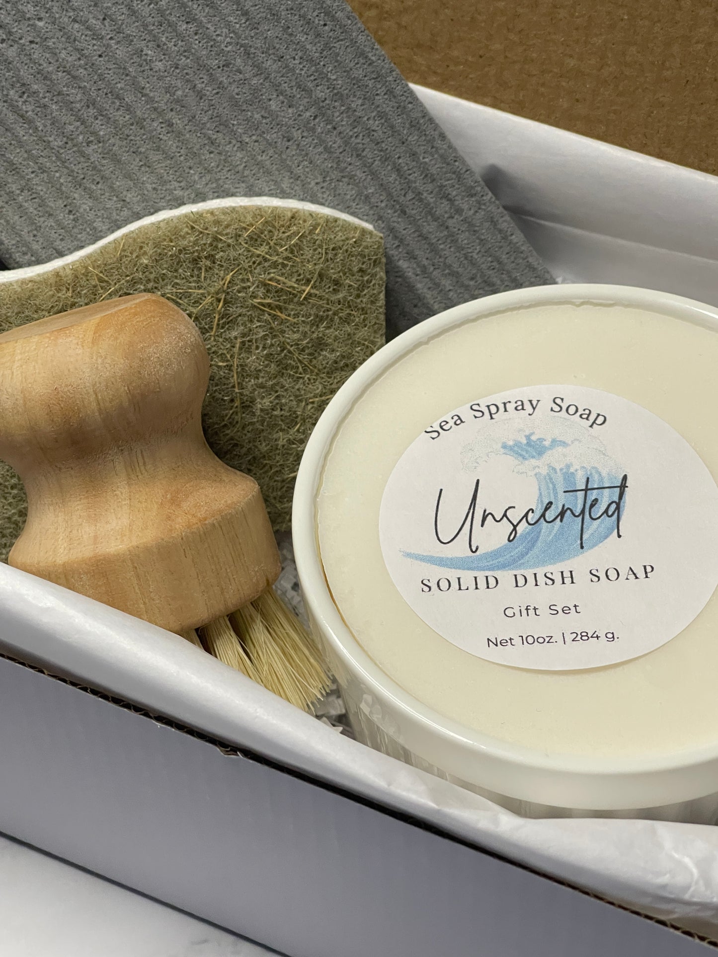 Unscented solid dish soap set with a brush and sponge in a white container.