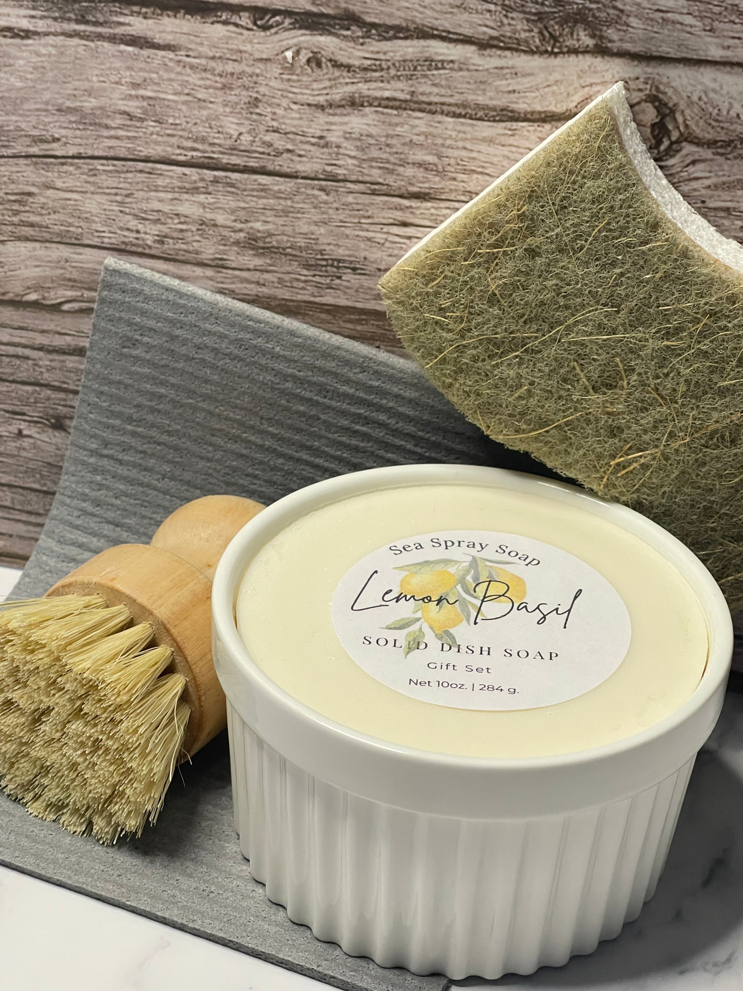 Solid dish bar with a brush and container on a wooden surface