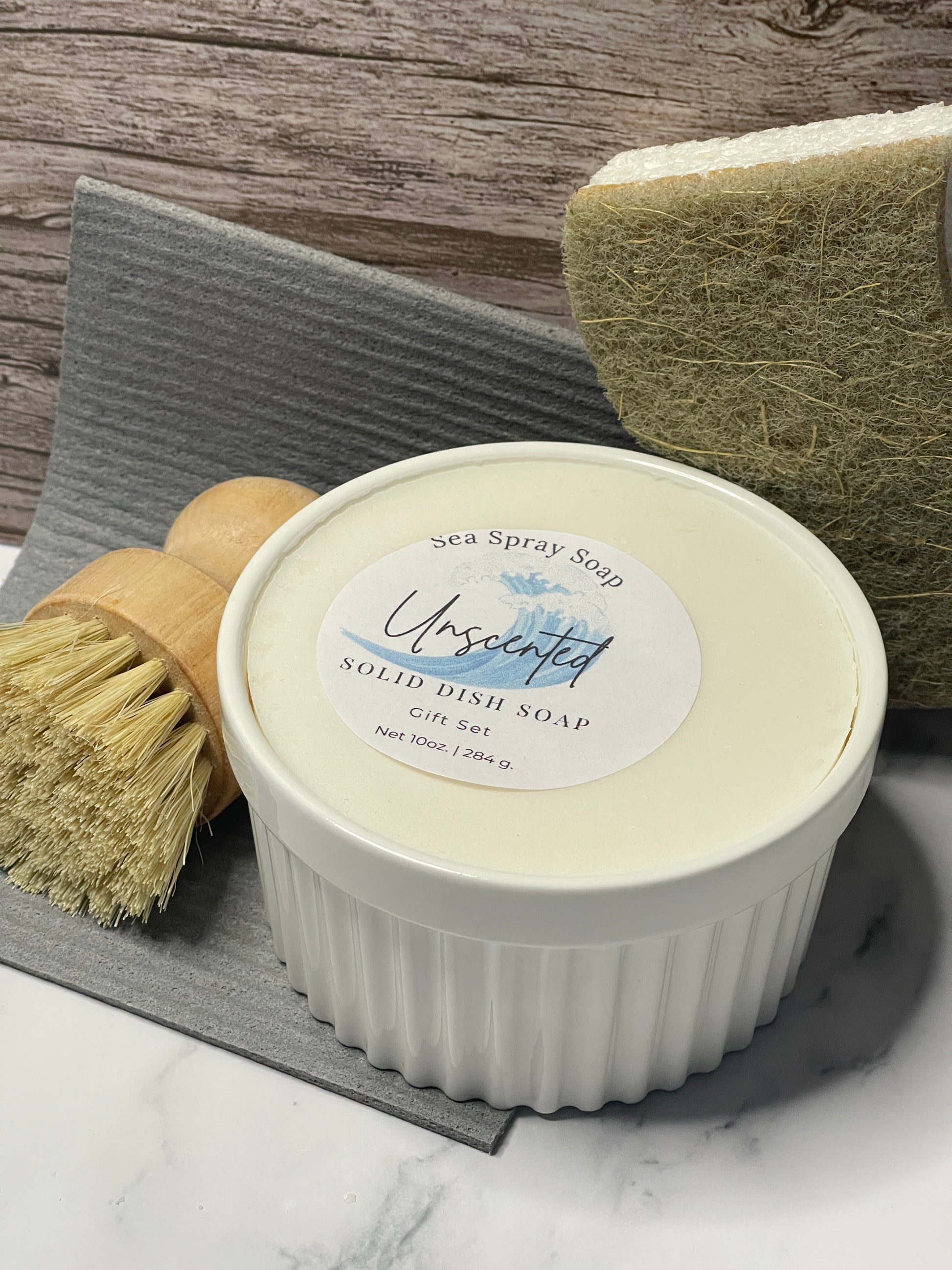 White dish scrubber with a label on a wooden surface